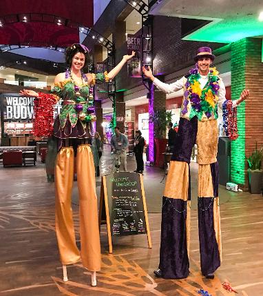 Female and Male Mardi Gras stilt walkers